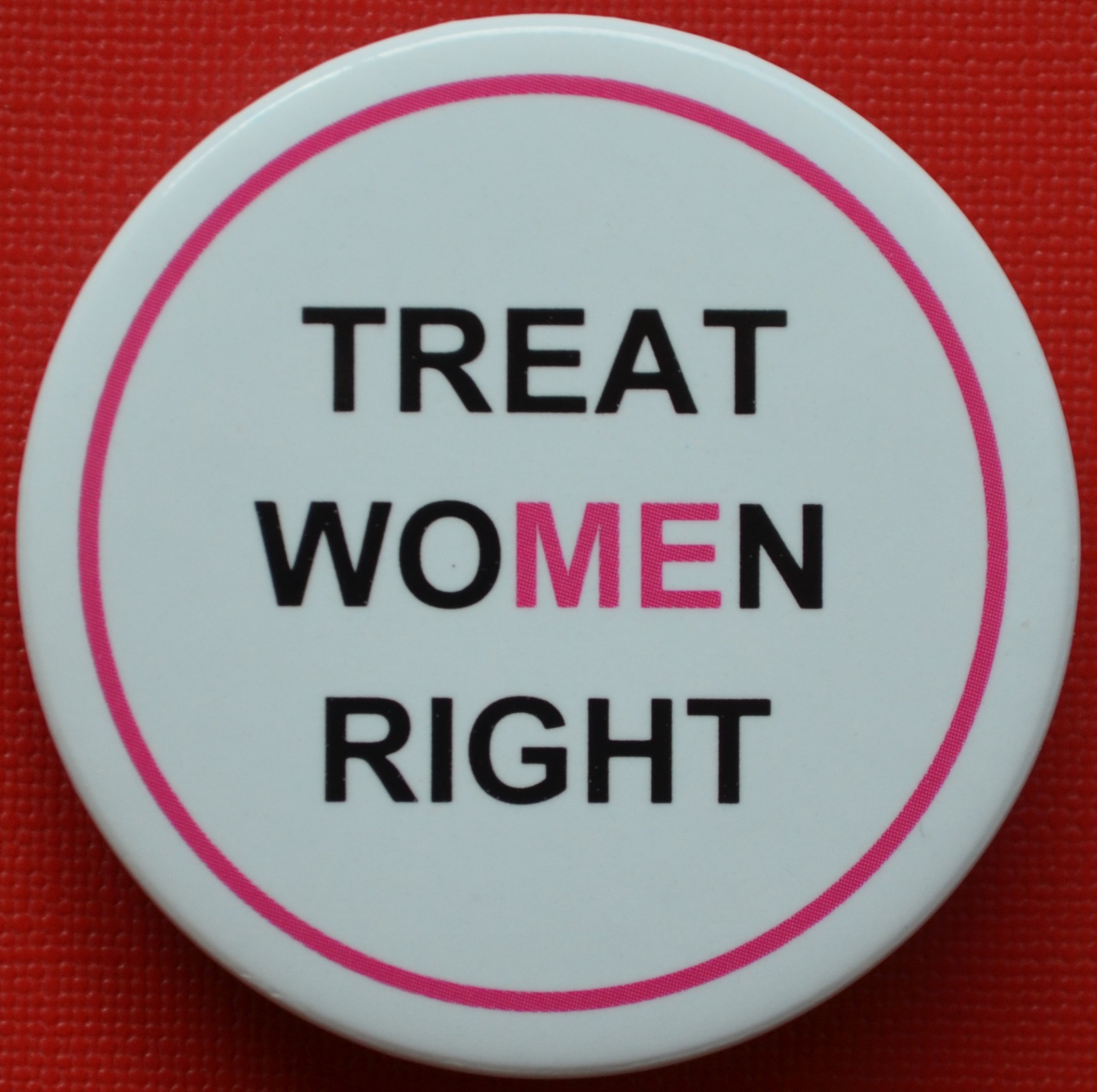 Treat Women Right Badge with black text and pink ME and surround