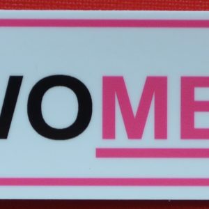 A pink and black sticker in a rectangle with an underline reminding drivers to Treat Women Right.
