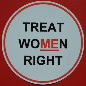 A Treat Women Right car bumper sticker in red and white.